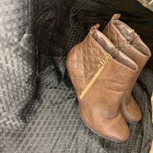 Brown heels with a gold excess zipper